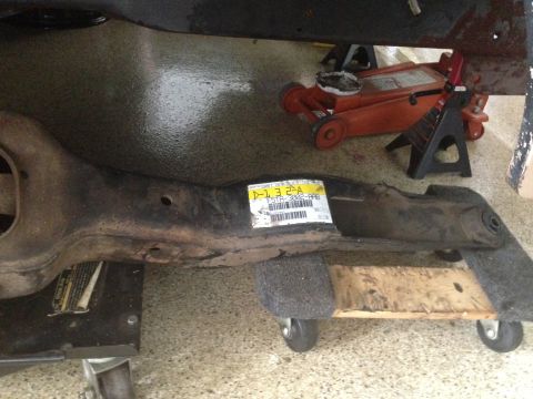 1986 Ford Bronco - A vehicle suspension component is shown with a yellow identification sticker attached.