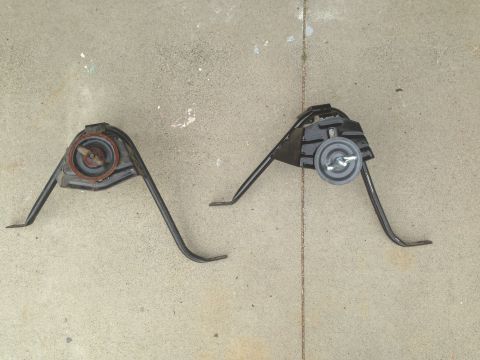 1986 Ford Bronco - Two engine mounts, likely for a Ford vehicle, are shown on a concrete surface.