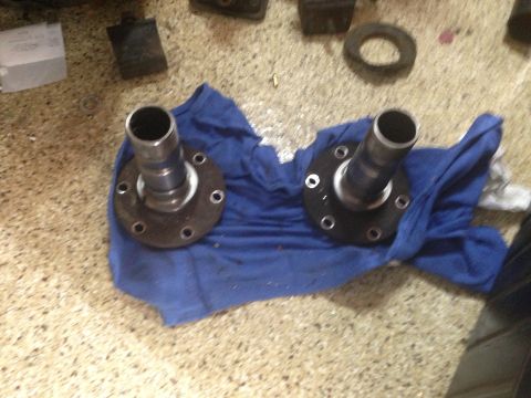 1986 Ford Bronco - Two front wheel hubs are shown resting on a blue cloth, likely for a vehicle part replacement or repair.