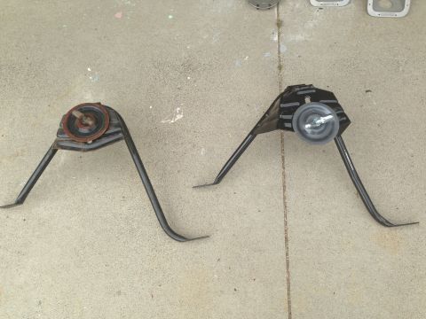 1986 Ford Bronco - Two vintage headlight assemblies are displayed on a concrete floor, likely for sale or restoration.