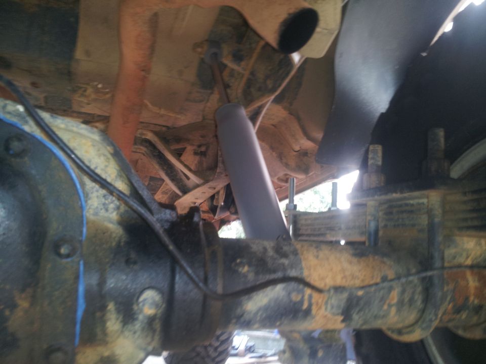 Underside view of a vehicle's rear axle assembly with a shock absorber