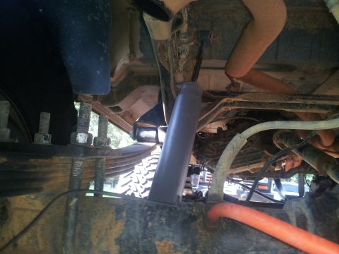 1988 Ford Bronco - The underside of a vehicle shows its suspension and exhaust system components.