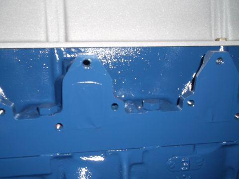 1967 Ford Mustang - Close-up view of a blue engine block, showing mounting points and hardware.