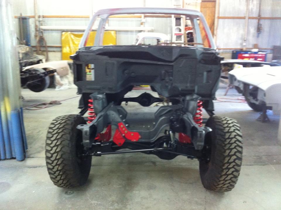 Truck chassis with red suspension components and large tires