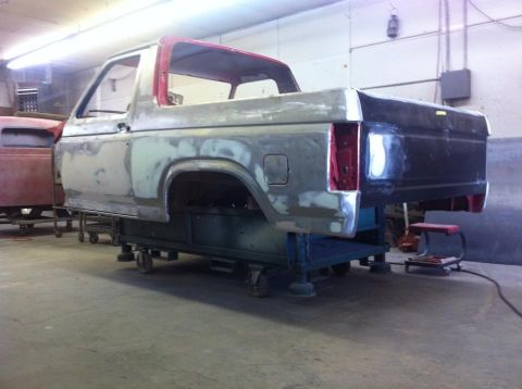 1982 Ford Bronco - This Ford Bronco body is undergoing bodywork and is mounted on a rolling stand in a workshop.