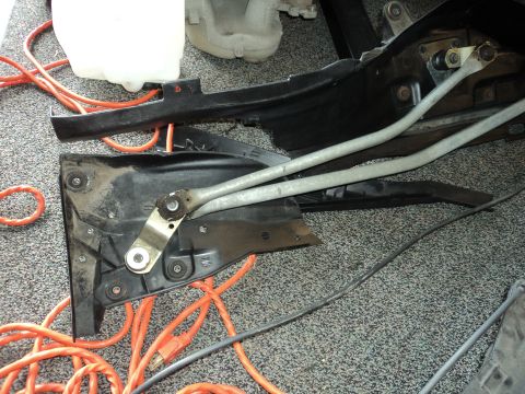 2004 Mercury Grand Marquis - Close-up of disassembled car wiper mechanism components on a carpeted surface.