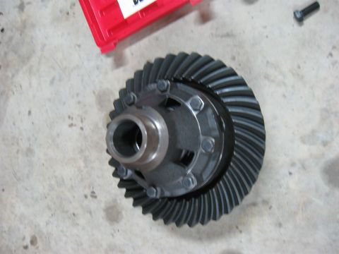 1990 Ford Bronco - A differential gear assembly is shown on a concrete surface, with a red toolbox in the background.