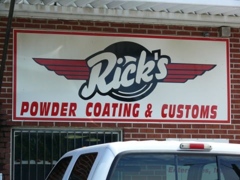 1976 Chevrolet Corvette - Sign for Rick's Powder Coating & Customs business. A white SUV is visible in the foreground.