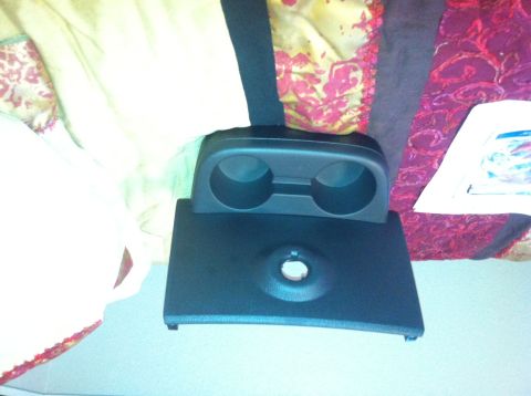 1982 Ford Bronco - This is a part of a vehicle's interior, likely a cup holder assembly from the center console.