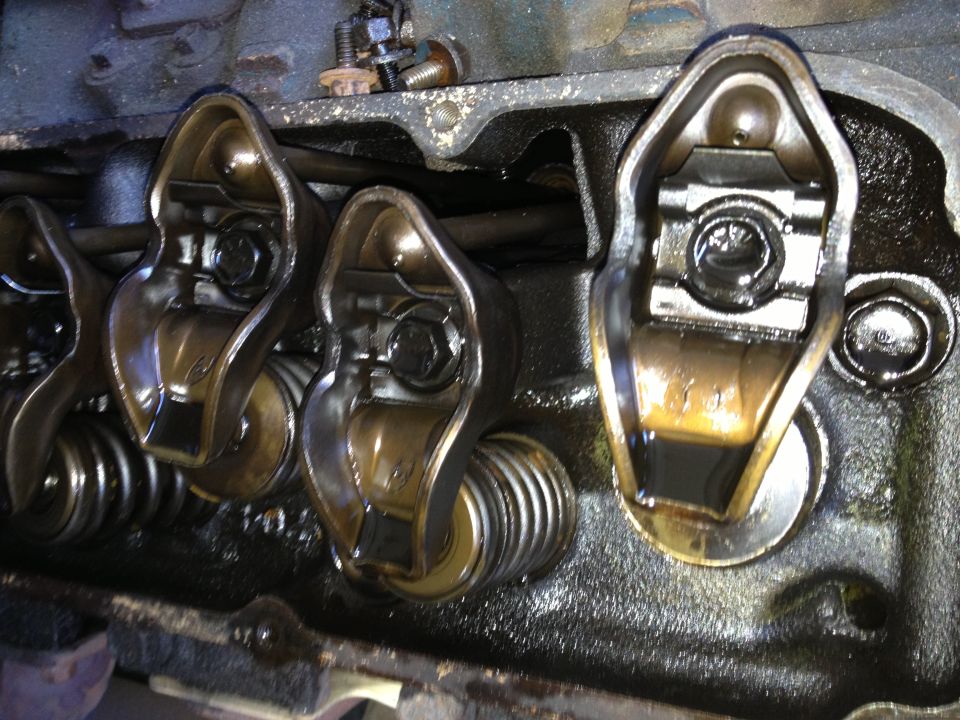 Close-up of engine valve train with rocker arms and springs visible