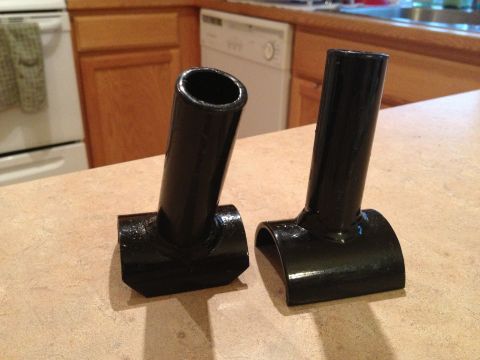 2005 Jeep Wrangler - Two black metal parts, likely components for an OR-Fab cage, are displayed on a kitchen countertop.