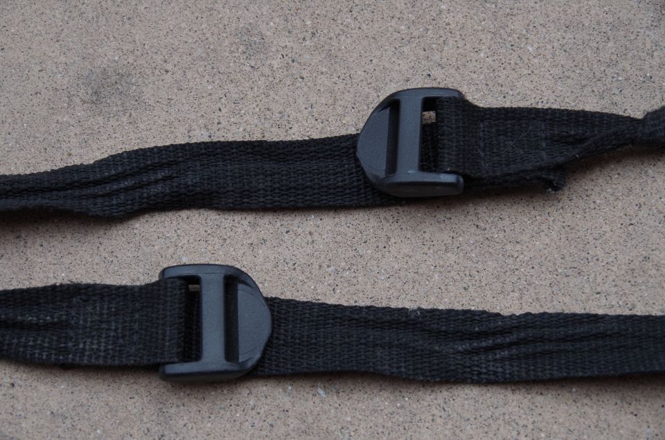 Two black fabric straps with black plastic buckles, one above the other. SuperMotors logo visible