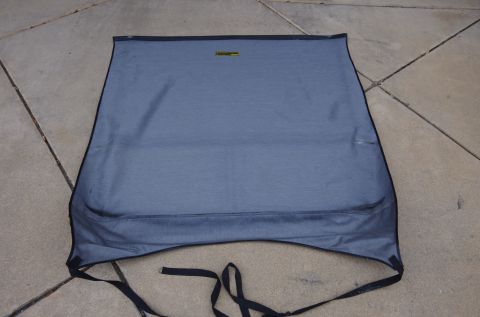 1983 Ferrari Enzo - A blue fabric convertible top is shown laid out flat on a concrete patio, with black straps attached.