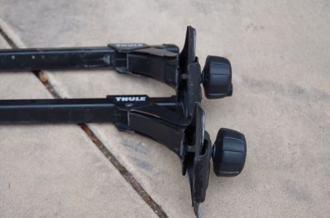 1983 Ferrari Enzo - Close-up of Thule roof rack components, showing the mounting mechanism and crossbars.