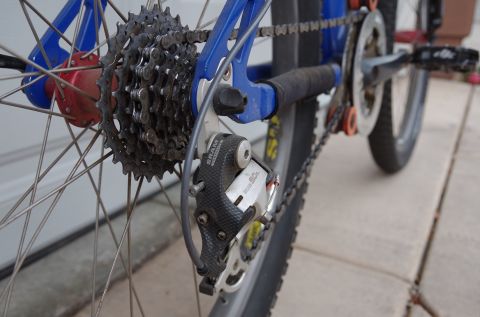 1983 Ferrari Enzo - Close-up view of the rear derailleur and cassette system on a bicycle.