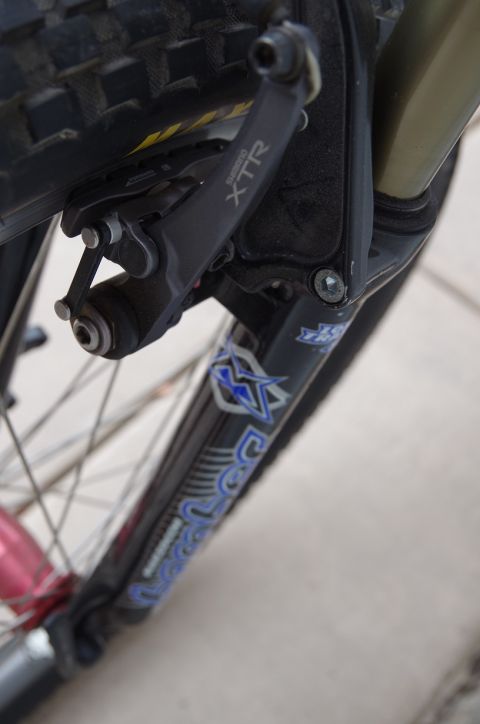 1983 Ferrari Enzo - Detail of a bicycle's front fork and brake system, showing Shimano XTR components.