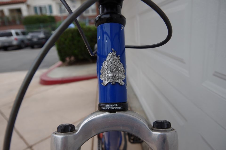 Blue bicycle frame with Intense Racing flame logo and Tioga Alchemy headset