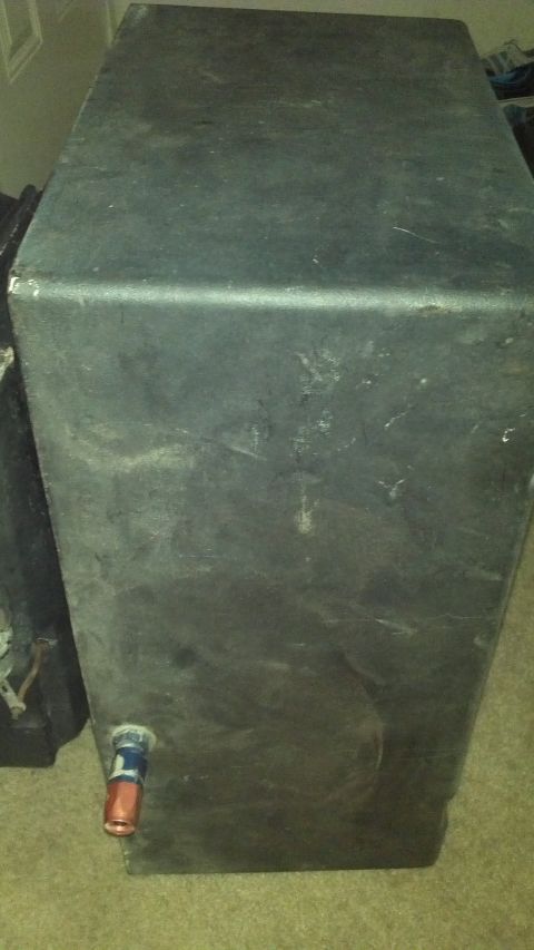 1987 Ford Bronco - This is a black fuel tank with a red and blue fitting visible on the side.