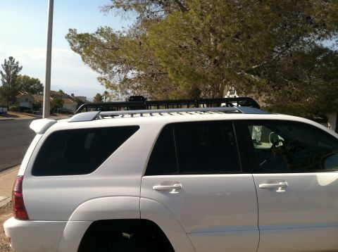 2003 Toyota 4Runner - This white 2003 Toyota 4Runner is parked outside on a sunny day with trees in the background.