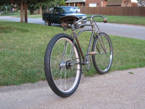1994 Ford Bronco - A vintage bicycle is parked on a sidewalk with a green pickup truck in the background.