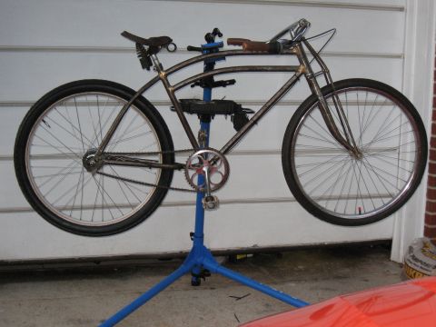 1994 Ford Bronco - A custom bicycle is mounted on a repair stand, showing its metal frame and spoked wheels.