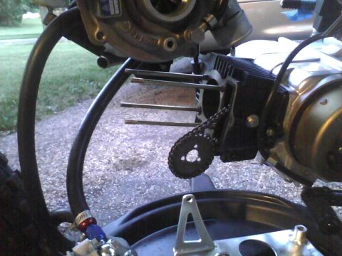 2003 Ford Crown Victoria - Close-up view of a motorcycle engine component, showing a chain and several threaded bolts.