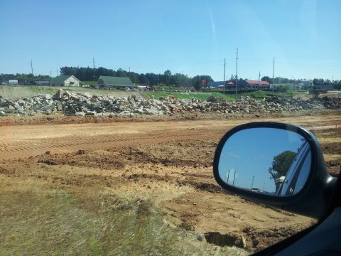 1986 Ford Bronco - Looking out at a construction site with a clear blue sky overhead.