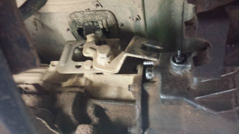 1987 Ford Bronco - Close-up view of the transmission linkage, showing a visible part number P-10.
