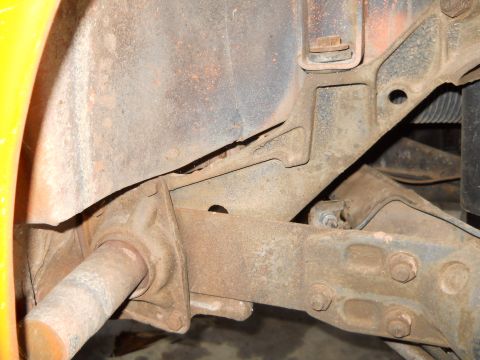 1992 Ford Bronco - Undercarriage view of vehicle frame and suspension components, showing signs of rust and wear.