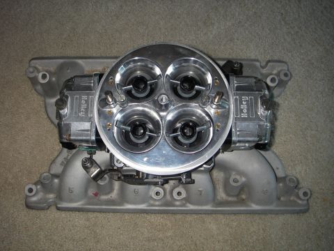 1972 Ford Ranchero - A close-up view of a dual Holley carburetor setup mounted on an aluminum intake manifold.