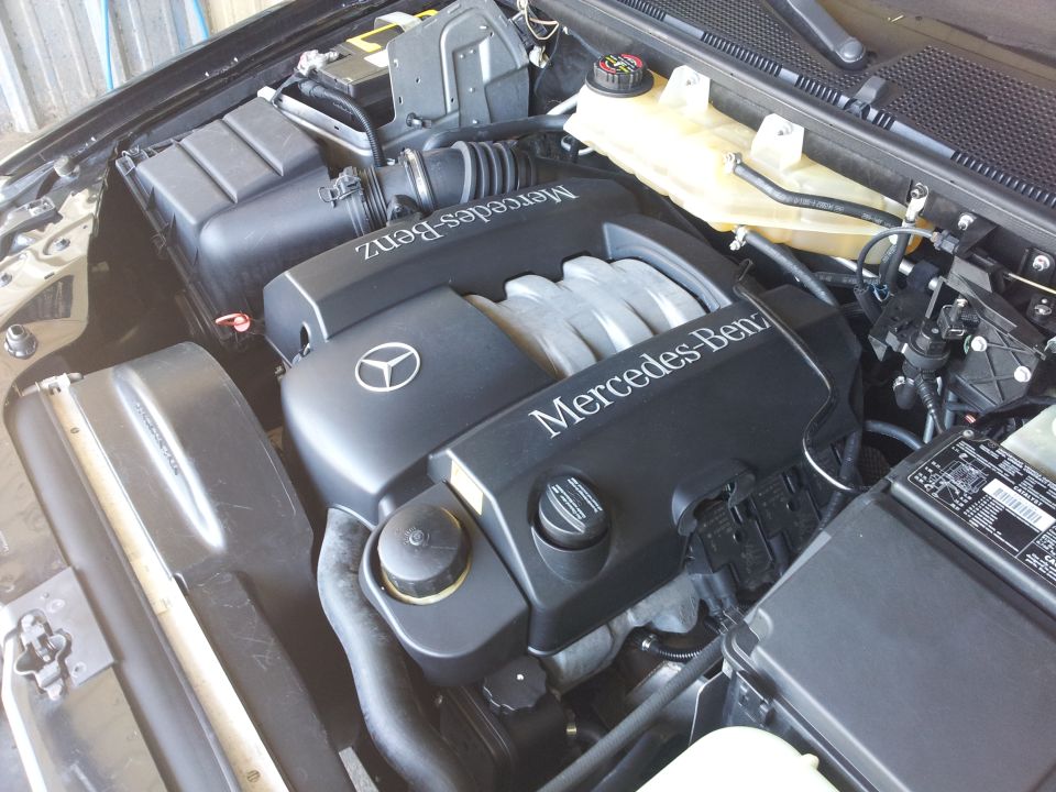 Mercedes-Benz engine bay with V-shaped engine cover and air intake system