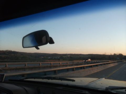 1990 Ford Bronco - Driving on a highway during sunset, with a view of the road ahead and the surrounding landscape.