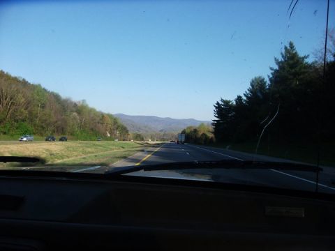1990 Ford Bronco - Driving on a highway through a mountainous landscape on a clear day.