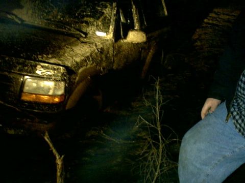 1995 Ford Bronco - This 1995 Ford Bronco is stuck in the mud in the dark.
