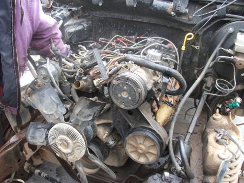 1990 Ford Bronco - Close-up view of a vehicle's engine bay, showing complex wiring and mechanical components.