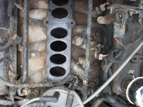 1990 Ford Bronco - This image shows a close-up view of an engine's intake manifold, with visible wiring and sensors.