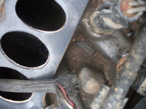 1990 Ford Bronco - Close-up view of an engine component with visible wiring and metal surfaces.