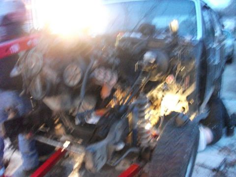1990 Ford Bronco - The engine bay of a vehicle is shown with the engine removed, indicating ongoing work or a swap.