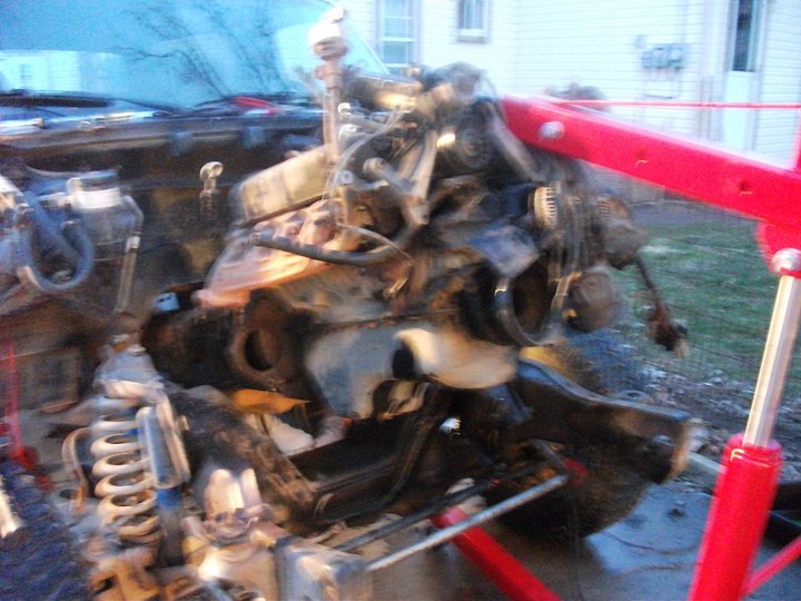 engine hoist lifting out an engine from a vehicle