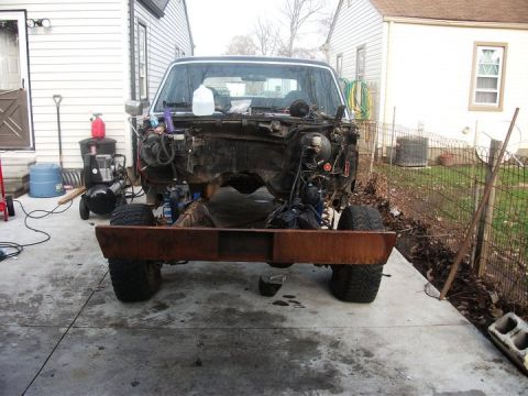 1990 Ford Bronco - Front view of a 1990 Ford Bronco chassis undergoing engine removal and repair.