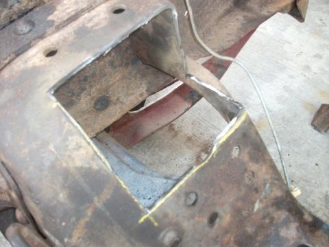 1990 Ford Bronco - A section of a vehicle frame has been cut and marked with yellow paint, indicating modification for a swap.