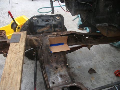 1990 Ford Bronco - Close-up of a vehicle's frame and fuel tank during what appears to be a repair or modification.