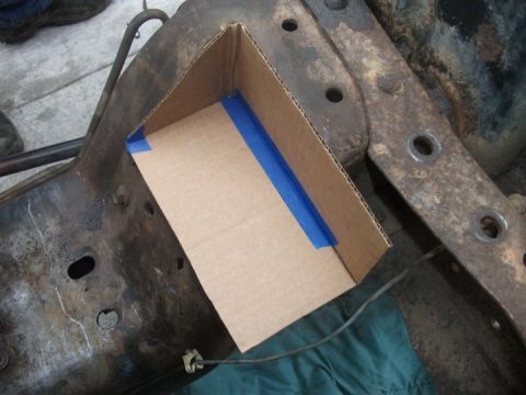 1990 Ford Bronco - Cardboard template being used on a rusty vehicle frame.