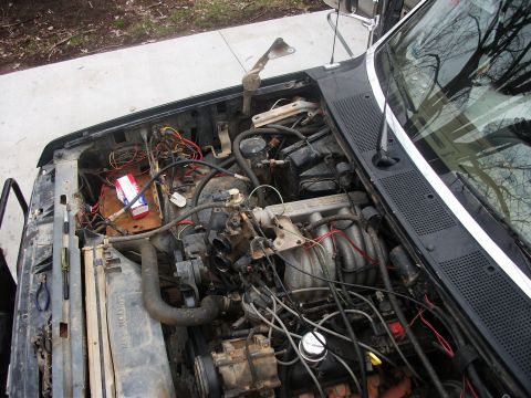 1990 Ford Bronco - Engine bay of a 1990 Ford Bronco, showing the V8 engine and associated components.