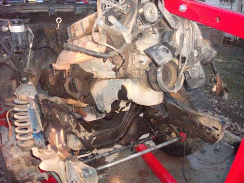 1990 Ford Bronco - Engine and suspension components are shown as a vehicle undergoes maintenance or repair.