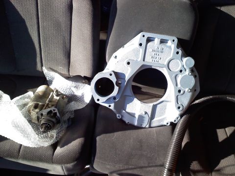 1990 Ford Bronco - Engine adapter plate and starter motor shown on car seats, likely for a 4BTA swap.