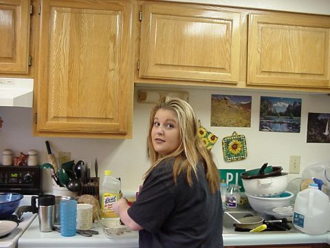 1995 Ford Bronco - A woman stands in a kitchen, looking over her shoulder.