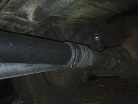 1995 Ford Bronco - Underside view of a driveshaft and U-joint assembly.