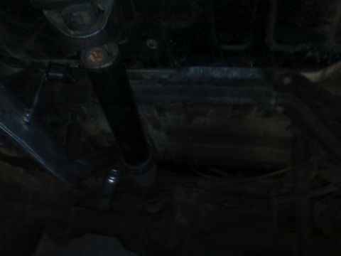 1995 Ford Bronco - This image shows the undercarriage of a vehicle, focusing on mechanical parts and the frame structure.