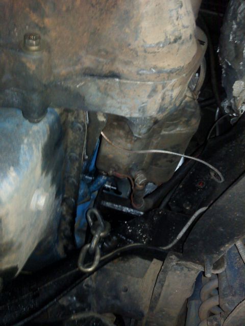 1995 Ford Bronco - Close-up view of engine and chassis components, showing a chain and some blue paint.